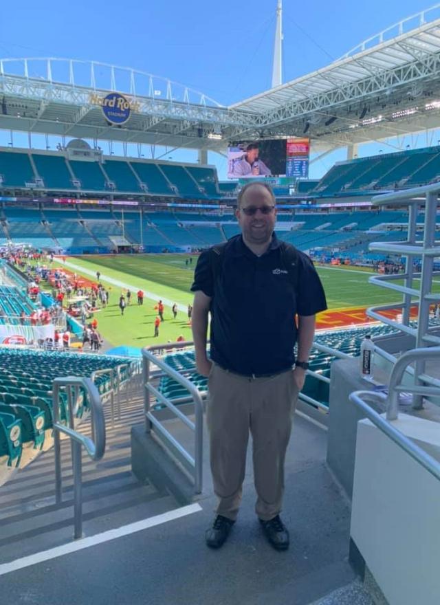 Joshua Hubbard in front of the football field while on assignment with ABC-7 to cover the Super Bowl