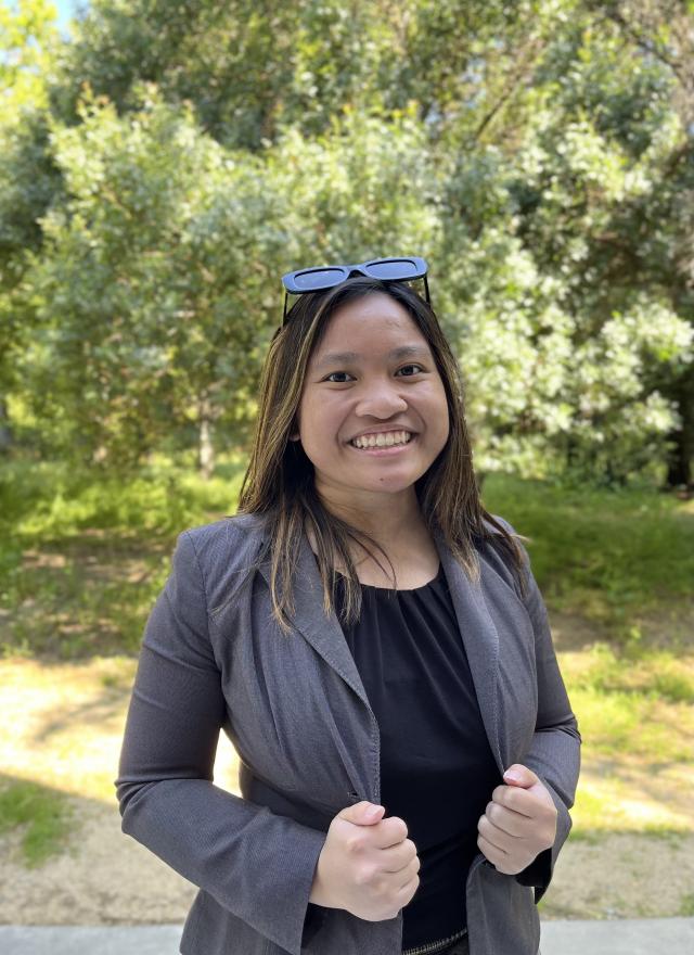 Angelina Cayabyab smiling and standing outside Gallagher Hall