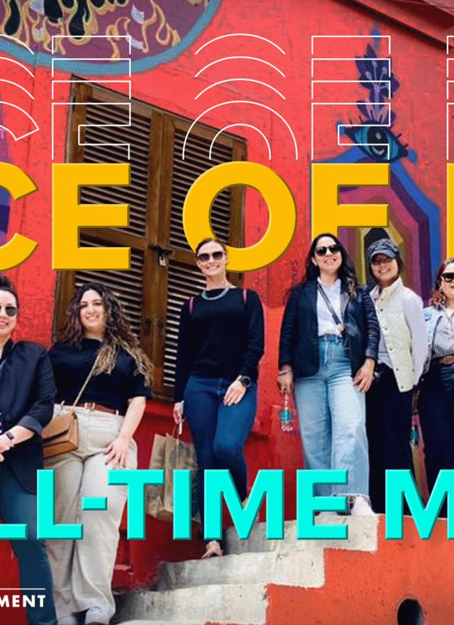 MBA students in Chile in front of a pink and orange mural