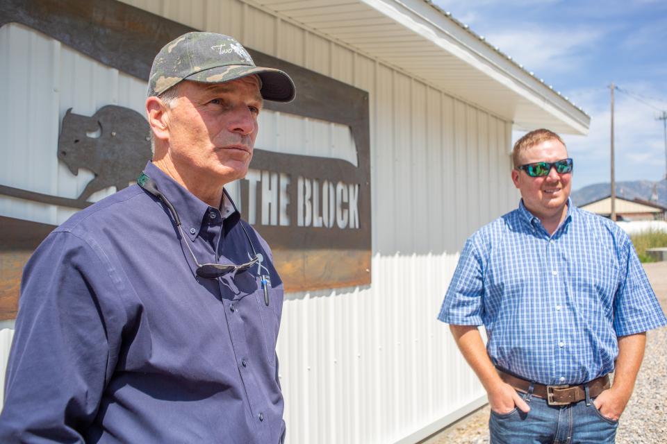 Wyoming Governor Mark Gordon and Grant Williams stand in front of The Block