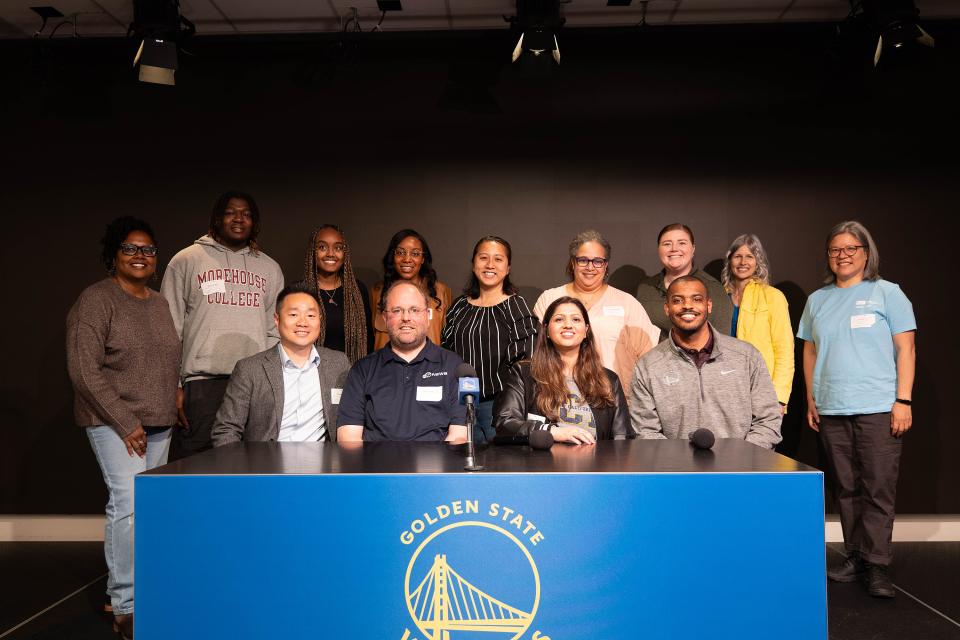 group of people behind a podium