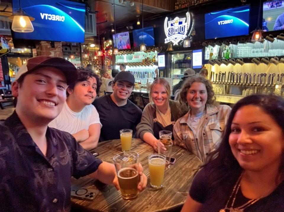 Gabe Fernandez with MPAc peers at a bar in Davis