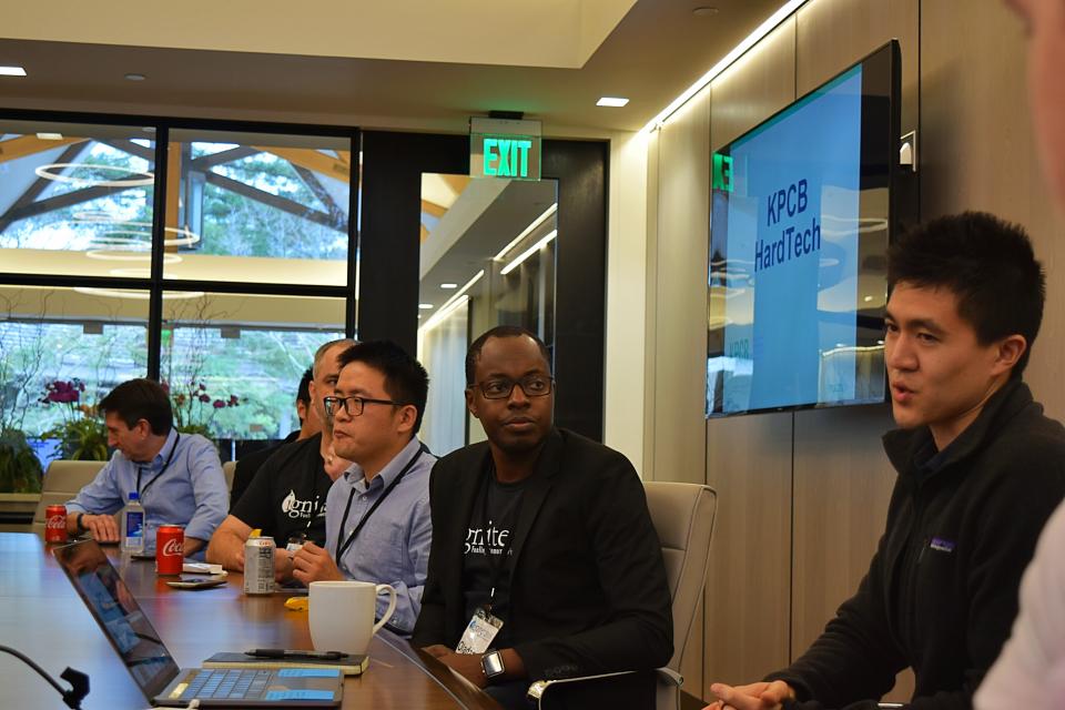 A group of conference attendees having conversations at a table